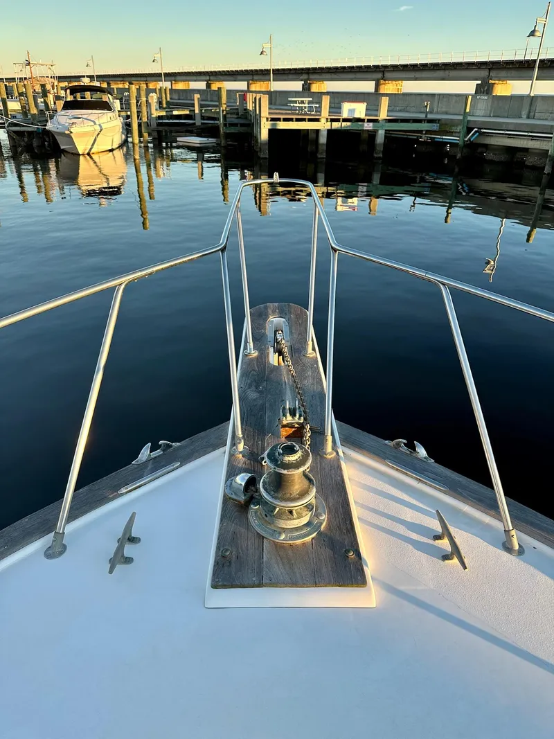 Slide: The Image of Bow of 1987 Post 46 SPORT yacht docked at marina, calm water reflections. - 2