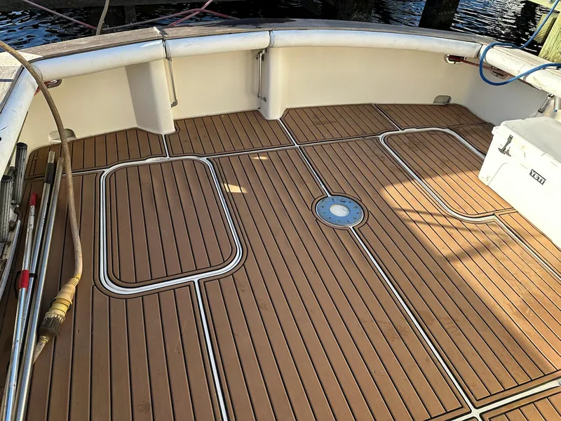 Slide: The Image of 1987 Post 46 SPORT boat deck with teak flooring and fishing equipment. - 27