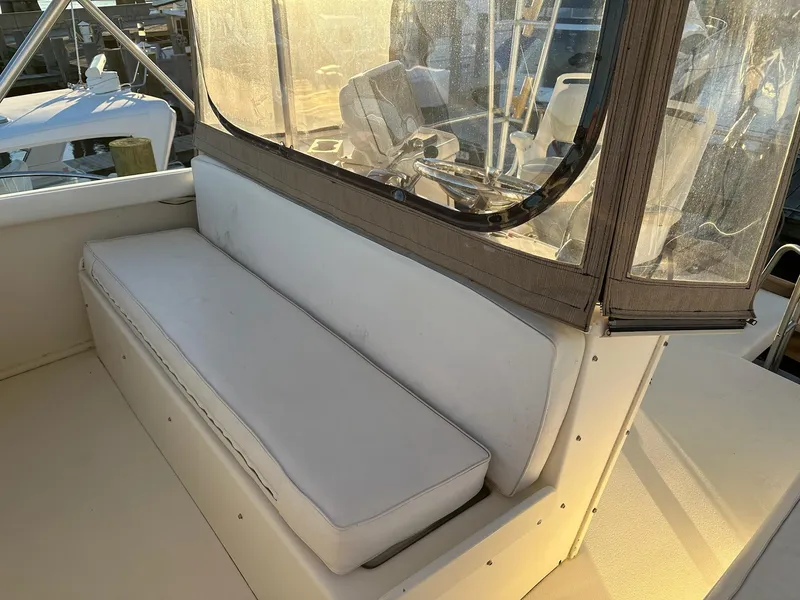 Slide: The Image of 1987 Post 46 SPORT boat interior with white seating and clear enclosure. - 6