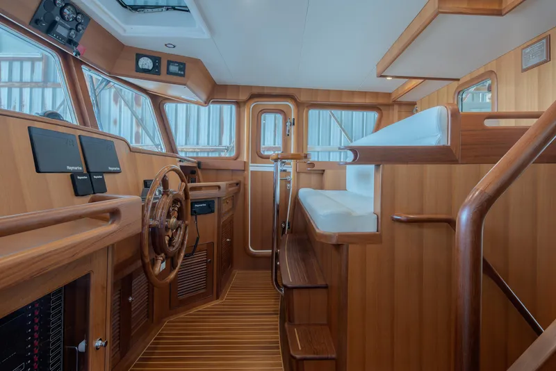 Slide: The Image of Interior of 2026 Selene 49 Classic Explorer yacht with wooden helm and seating. - 17