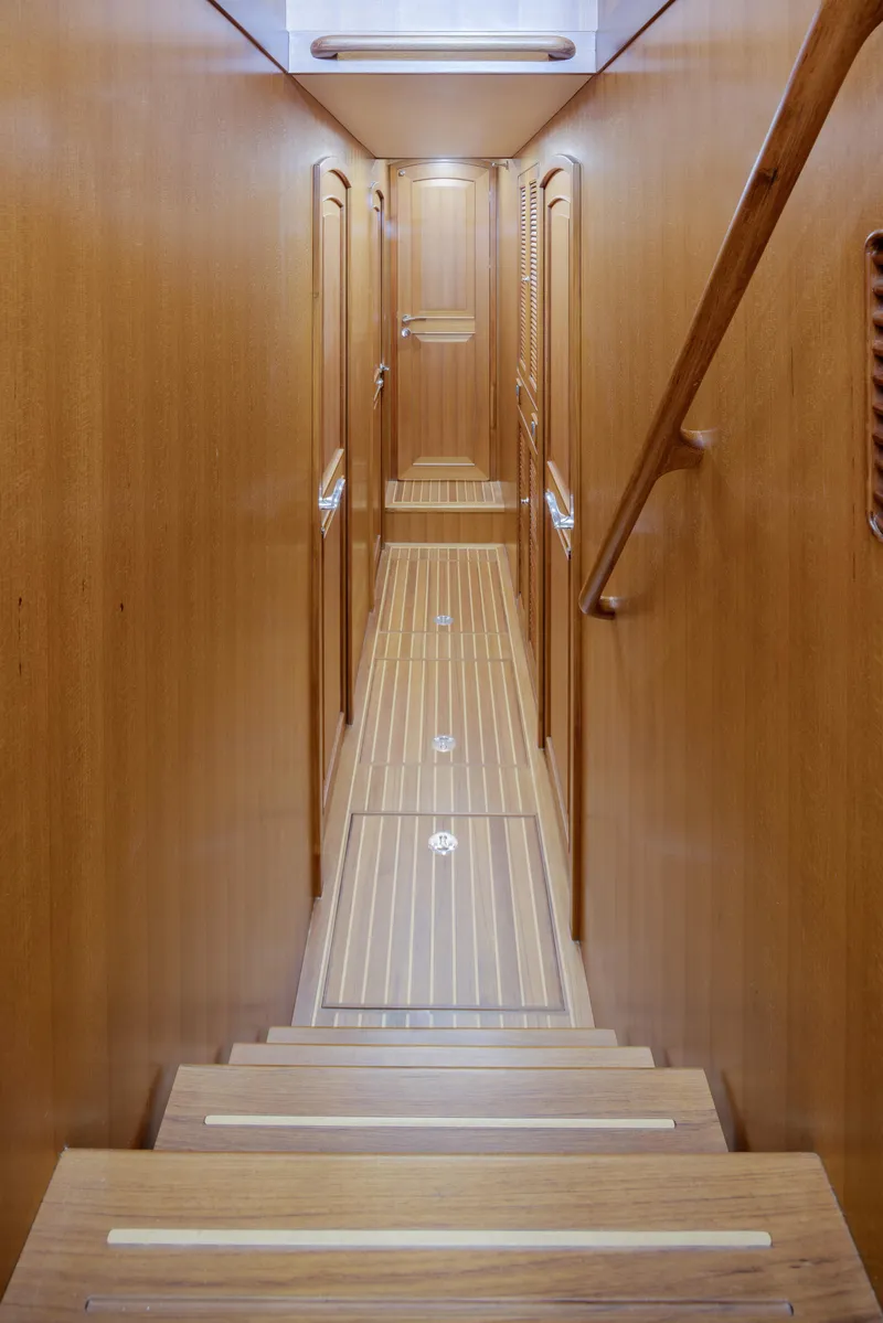Slide: The Image of Interior hallway of 2026 Selene 49 Classic Explorer yacht, featuring wooden paneling and steps. - 19