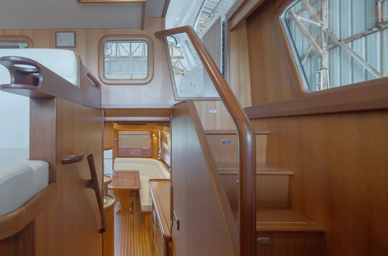 Slide: The Image of Interior of 2026 Selene 49 Classic Explorer yacht, featuring wooden stairs and seating area. - 24