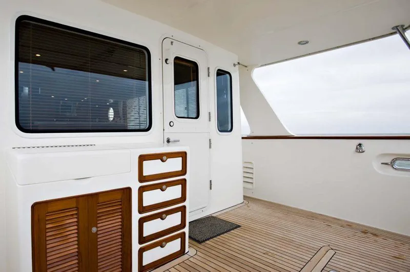 Slide: The Image of Selene 49 Classic Explorer 2026 yacht deck with wooden flooring and white cabinetry. - 7