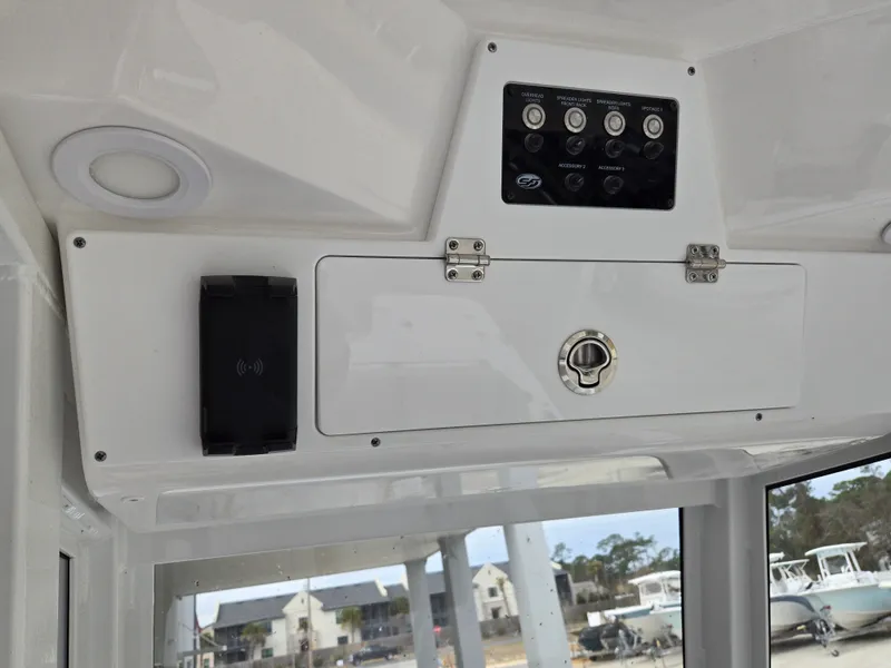 Slide: The Image of 2024 Sea Fox 251 Bay Fox control panel and storage compartment. - 10