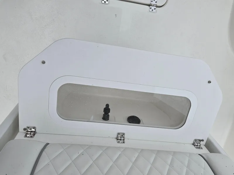 Slide: The Image of 2024 Sea Fox 251 Bay Fox boat interior compartment with white cushioned seating. - 12