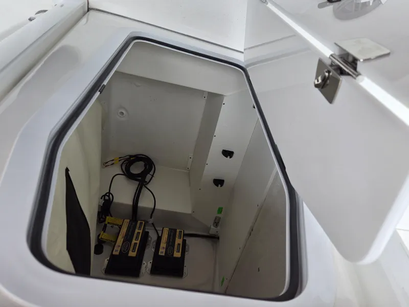Slide: The Image of 2024 Sea Fox 251 Bay Fox storage compartment with battery setup. - 14