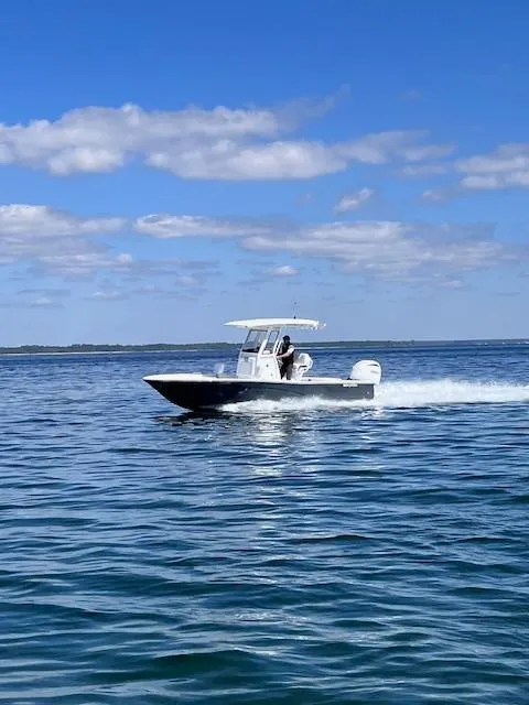 Slide: The Image of 2024 Sea Fox 251 Bay Fox cruising on open water under a clear blue sky. - 2