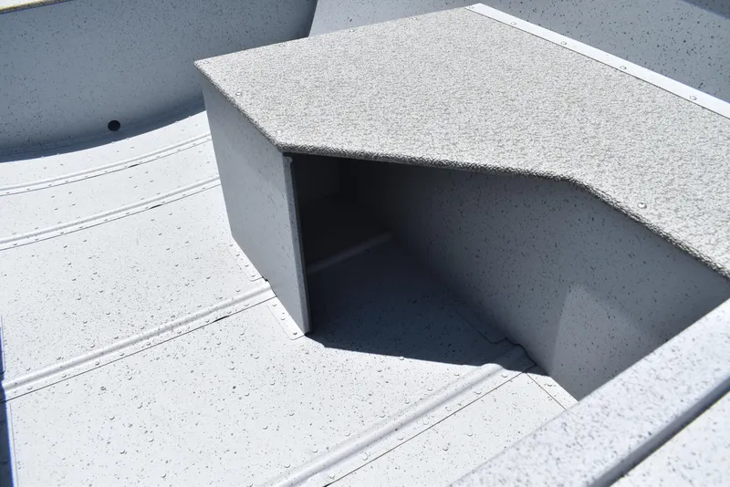 Slide: The Image of 2024 Lowe WV 1470 boat interior with textured flooring and storage compartment. - 11