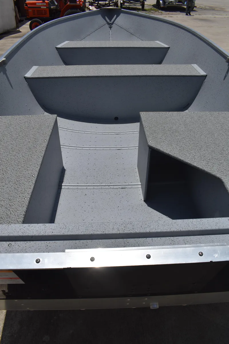 Slide: The Image of 2024 Lowe WV 1470 boat interior with gray seating and storage compartments. - 12
