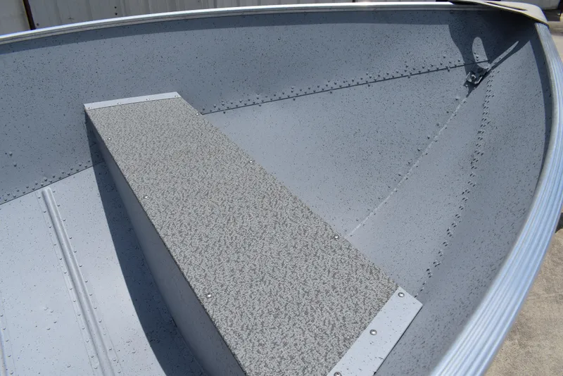 Slide: The Image of Interior of 2024 Lowe WV 1470 boat, featuring textured seating and riveted aluminum construction. - 4