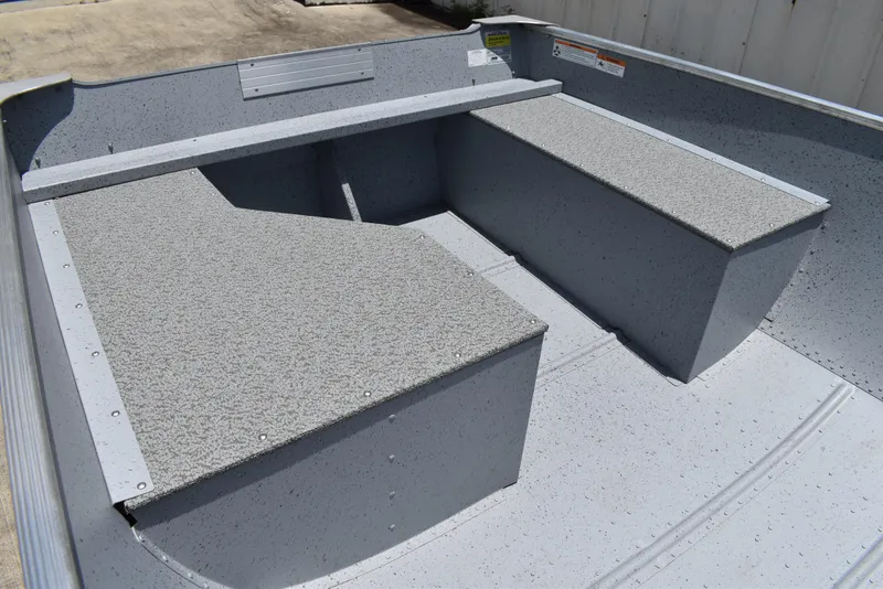 Slide: The Image of 2024 Lowe WV 1470 boat interior with textured seating and storage compartments. - 8