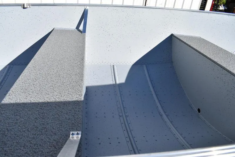 Slide: The Image of 2024 Lowe WV 1670 boat interior with gray textured flooring. - 7