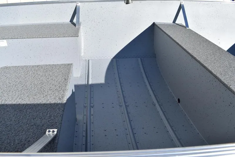Slide: The Image of 2024 Lowe WV 1670 boat interior with gray textured flooring. - 8