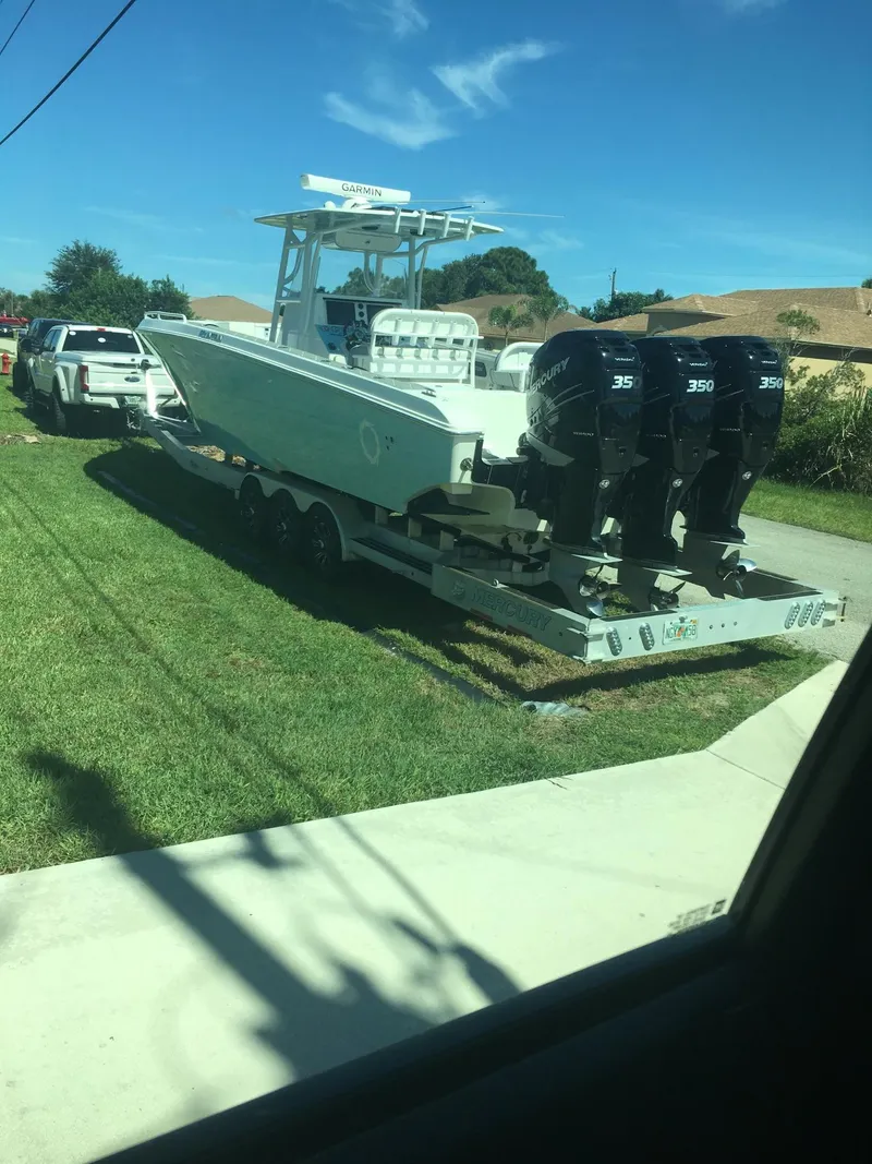 Slide: The Image of 2007 Fountain 38 CC Tournament Edition boat on trailer with triple outboard engines. - 18