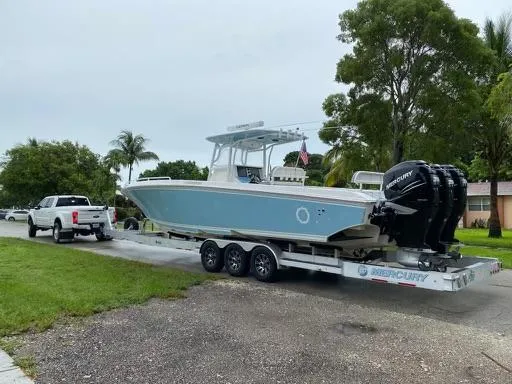 Slide: The Image of 2007 Fountain 38 CC Tournament Edition boat on trailer, towed by white truck. - 19
