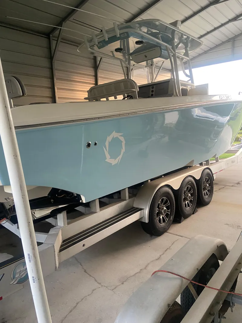 Slide: The Image of 2007 Fountain 38 CC Tournament Edition boat on a trailer in a covered storage area. - 20