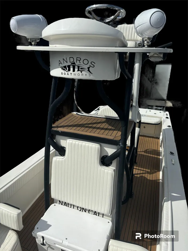 Slide: The Image of 2014 Andros Tarpon 26 boat interior with seating and helm station. - 10