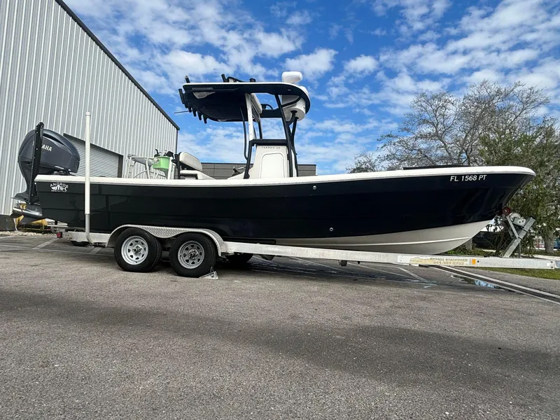 Slide: The Image of 2014 Andros Tarpon 26 boat on a trailer, parked outdoors. - 4