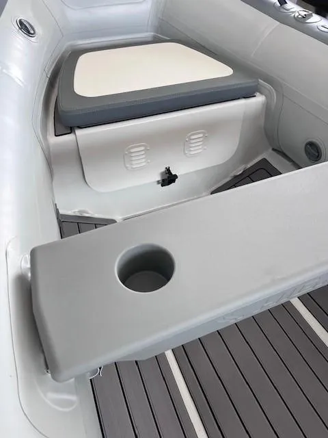 Slide: The Image of 2024 Highfield Classic 310 boat interior with seating and cup holder. - 6