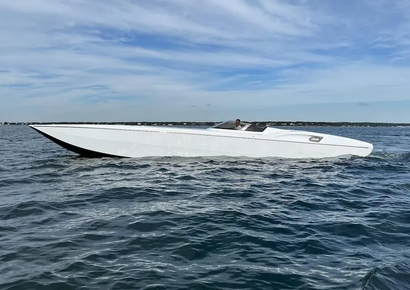 The Image of 2009 MTI 42' R/P speedboat cruising on open water. - 1