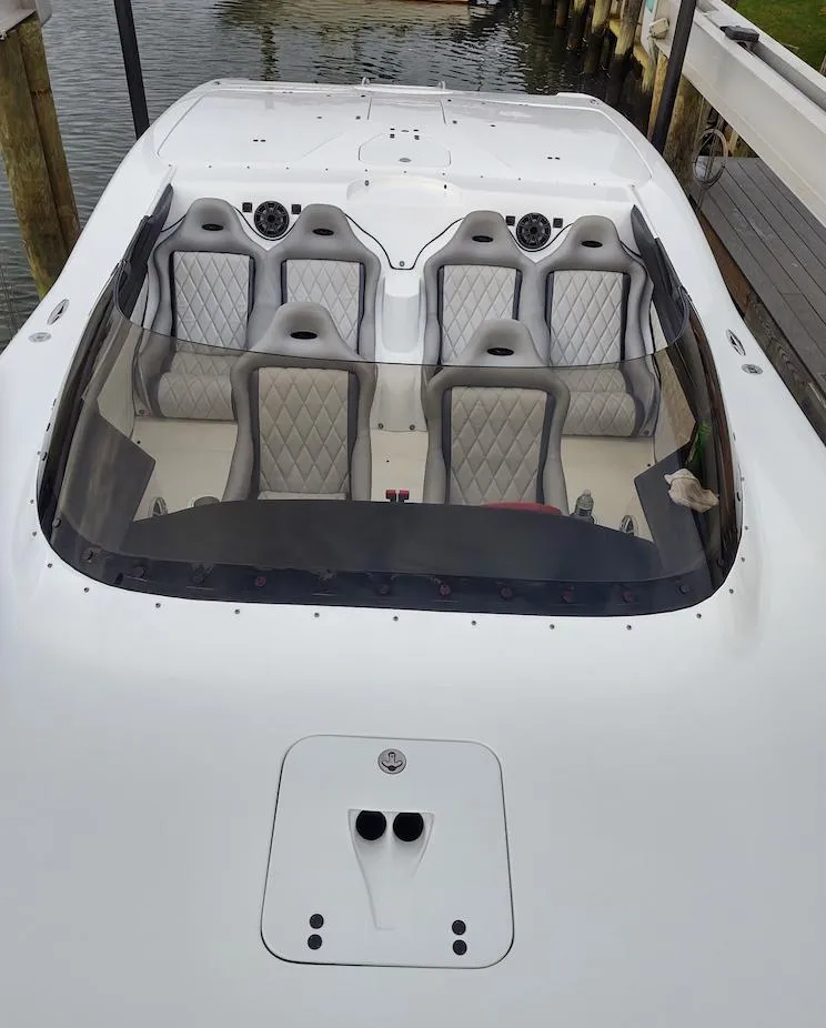 Slide: The Image of 2009 MTI 42' R/P speedboat with luxury seating docked by the water. - 3