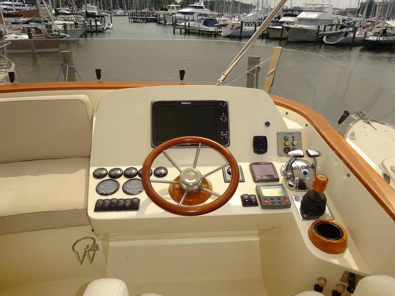 Slide: The Image of Helm of 2002 Hinckley Talaria 44 FB yacht with wooden steering wheel and navigation controls. - 10