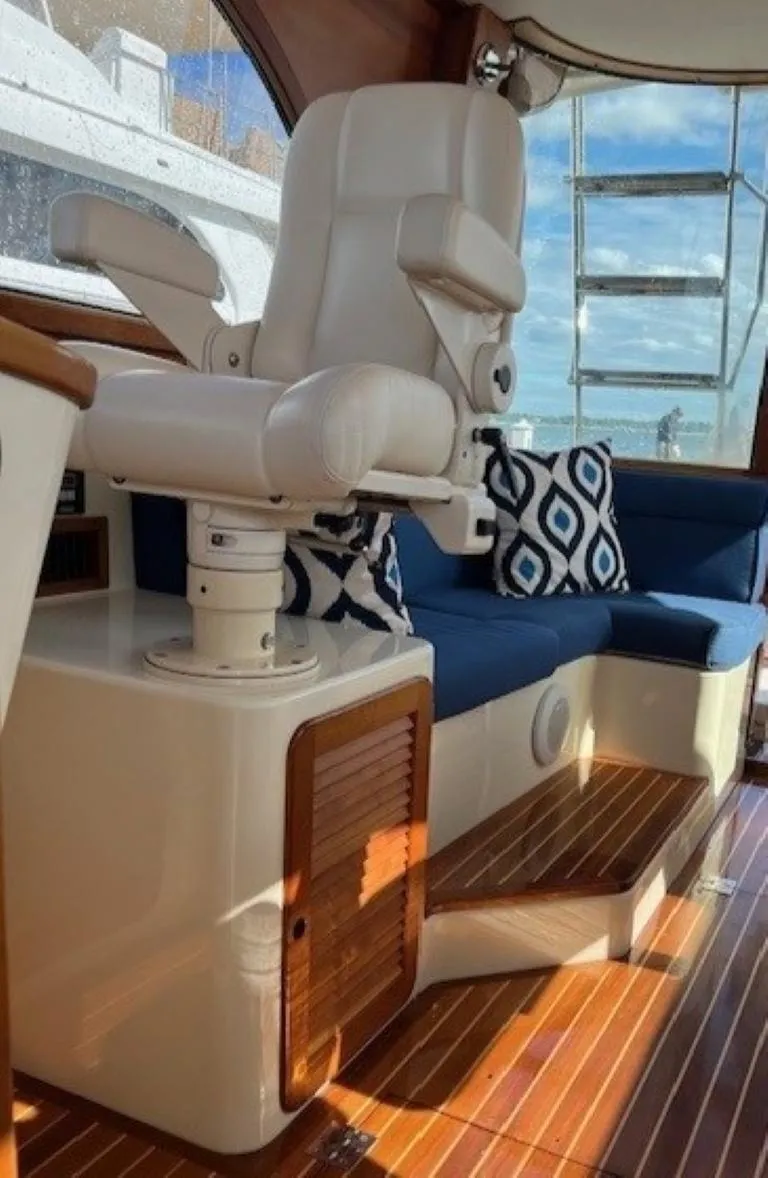 Slide: The Image of Luxury interior of 2002 Hinckley Talaria 44 FB yacht with plush seating and elegant design. - 13