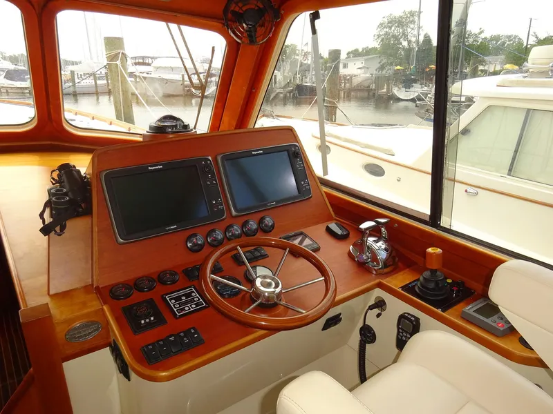 Slide: The Image of Helm of 2002 Hinckley Talaria 44 FB with dual screens and wooden steering wheel. - 14