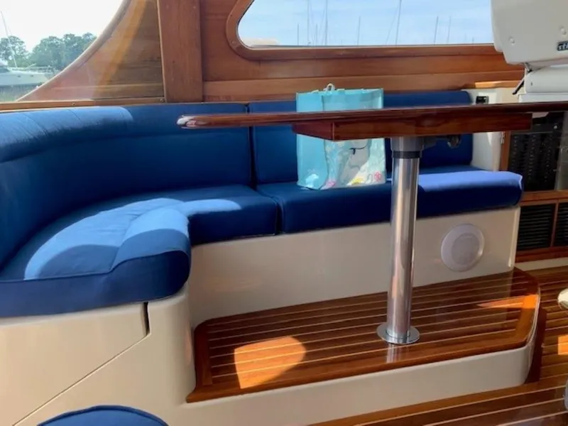 Slide: The Image of Interior of 2002 Hinckley Talaria 44 FB with blue seating and wooden table. - 15