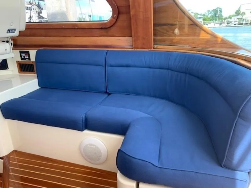 Slide: The Image of Blue cushioned seating on 2002 Hinckley Talaria 44 FB yacht, wooden interior, dockside view. - 16