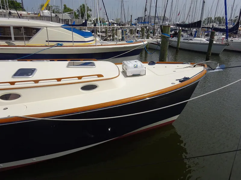 Slide: The Image of 2002 Hinckley Talaria 44 FB yacht docked in marina, featuring sleek design and classic styling. - 2