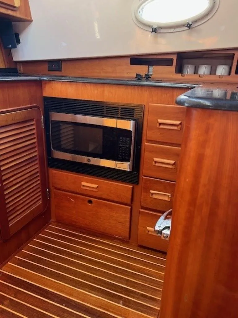 Slide: The Image of Hinckley Talaria 44 FB 2002 yacht kitchen with microwave and wooden cabinetry. - 20