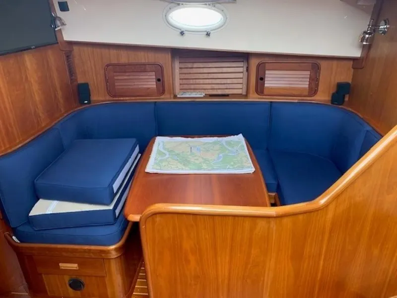 Slide: The Image of Cozy interior of 2002 Hinckley Talaria 44 FB with blue seating and wooden table. - 22