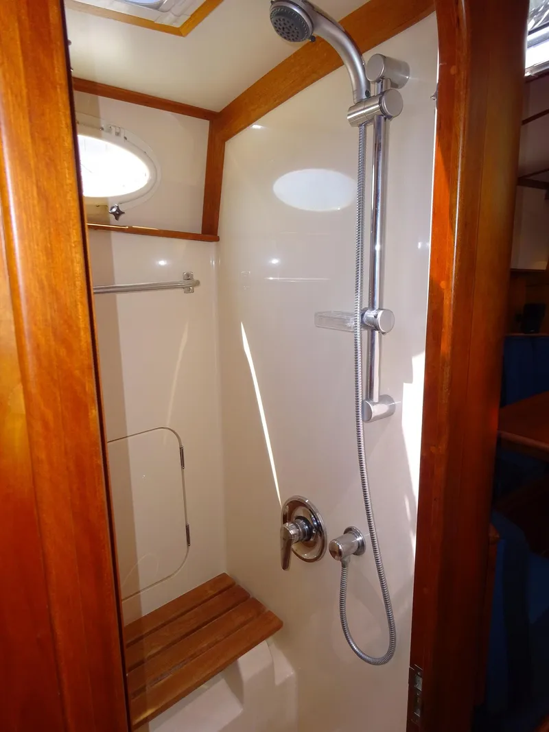 Slide: The Image of Shower area in 2002 Hinckley Talaria 44 FB yacht with wooden accents and modern fixtures. - 23