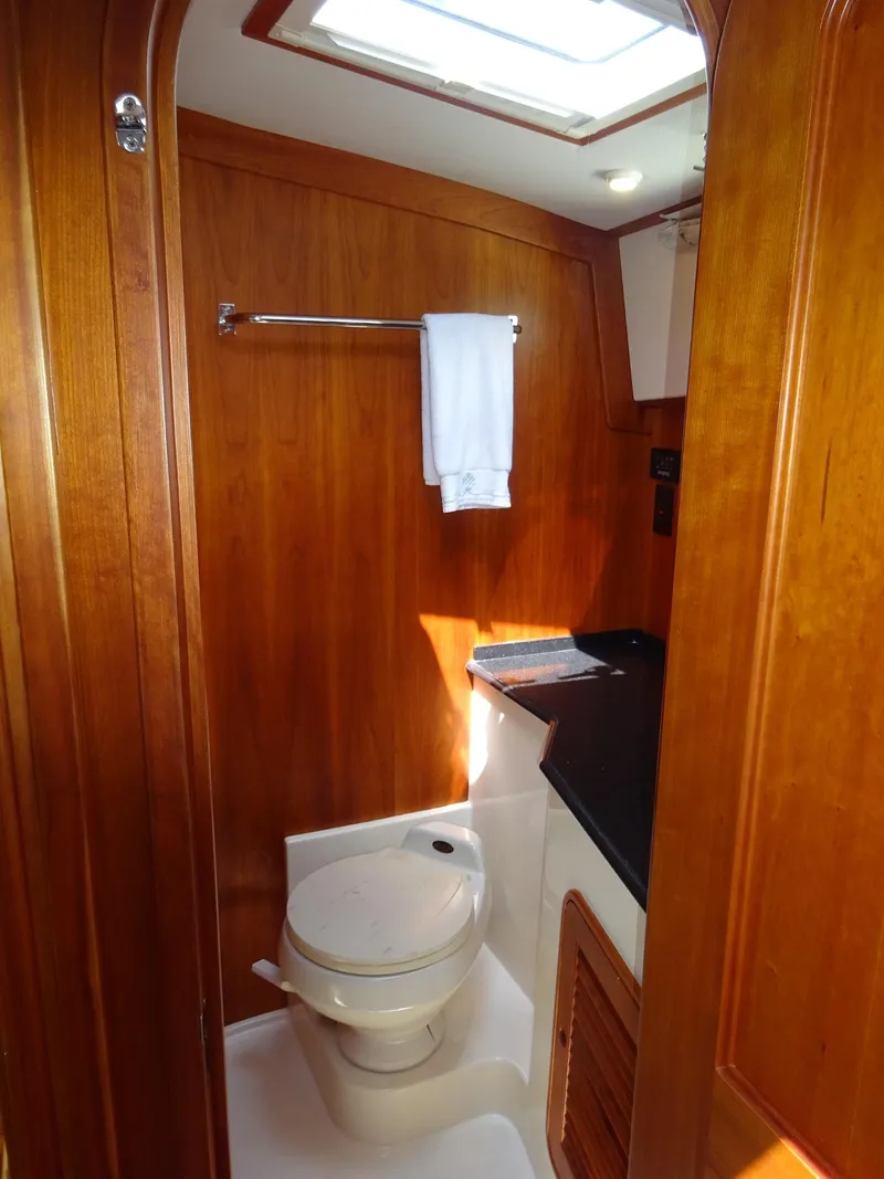 Slide: The Image of Hinckley Talaria 44 FB 2002 yacht bathroom with wooden interior and skylight. - 26