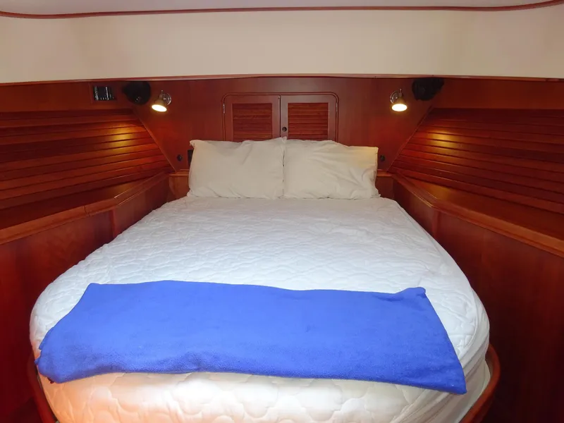 Slide: The Image of Luxurious cabin interior of 2002 Hinckley Talaria 44 FB with cozy bed and wooden finish. - 27