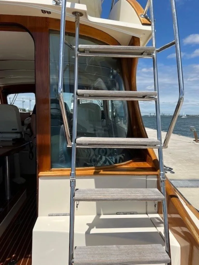 Slide: The Image of 2002 Hinckley Talaria 44 FB yacht with exterior ladder and wooden accents. - 32