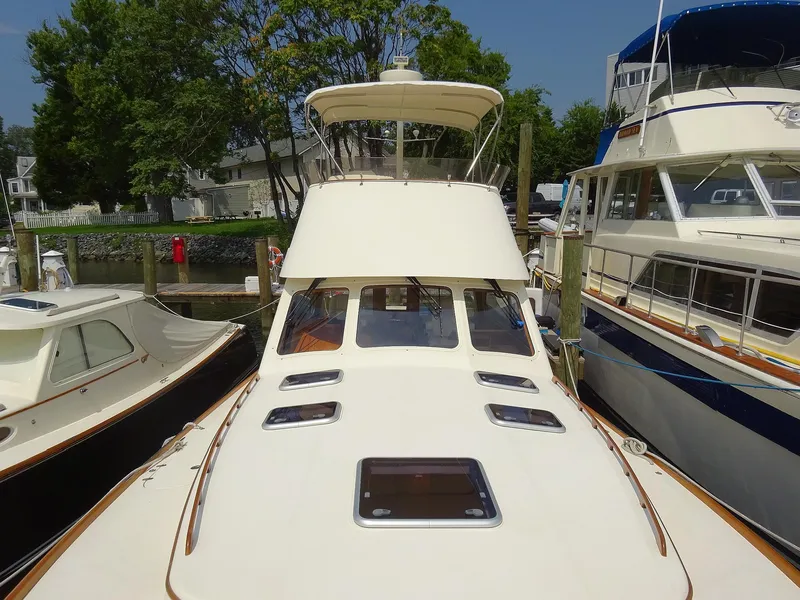 Slide: The Image of Hinckley Talaria 44 FB 2002 yacht docked, showcasing sleek design and spacious deck. - 4