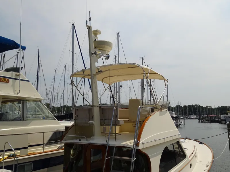 Slide: The Image of 2002 Hinckley Talaria 44 FB yacht docked at marina with sailboats in background. - 6