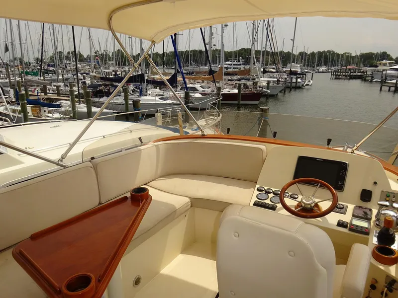 Slide: The Image of 2002 Hinckley Talaria 44 FB yacht interior with helm, docked at marina. - 8