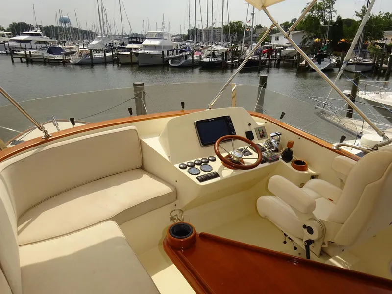 Slide: The Image of Helm of 2002 Hinckley Talaria 44 FB yacht with marina view. - 9