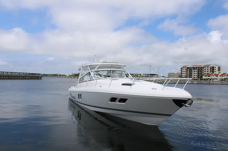 Slide: The Image of 2020 Intrepid 475 Sport Yacht cruising on calm waters under a partly cloudy sky. - 10