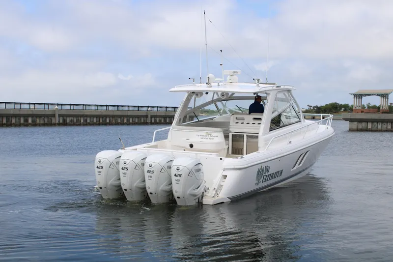 Slide: The Image of 2020 Intrepid 475 Sport Yacht with quad engines cruising on calm water. - 11