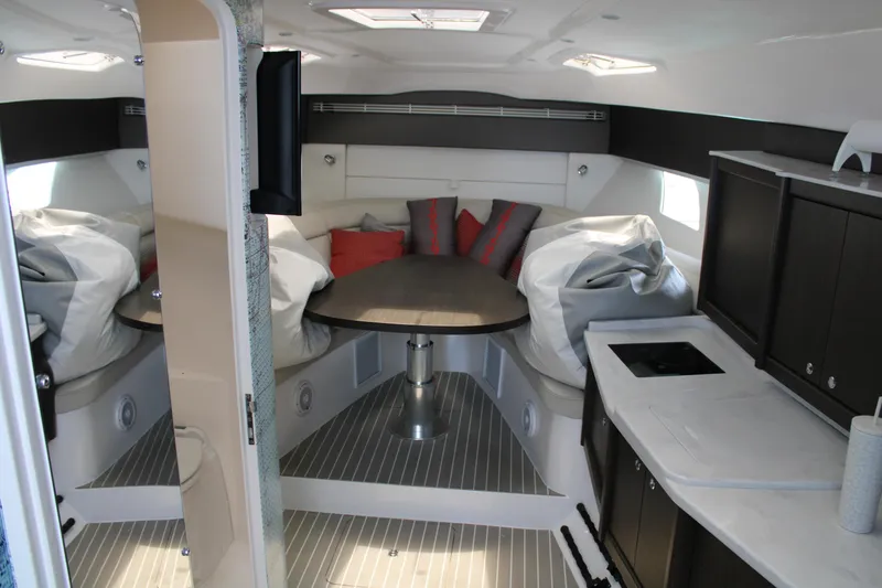 Slide: The Image of Interior of 2020 Intrepid 475 Sport Yacht with modern furnishings and compact kitchen. - 13