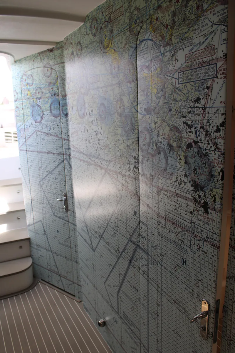 Slide: The Image of Interior view of 2020 Intrepid 475 Sport Yacht with nautical chart wall design. - 14