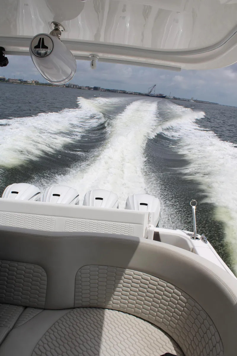 Slide: The Image of 2020 Intrepid 475 Sport Yacht cruising on open water, view from the stern. - 17
