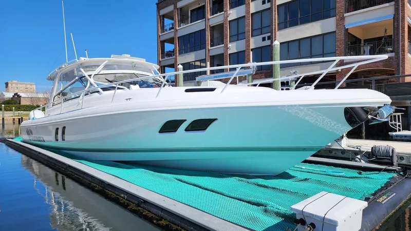 Slide: The Image of 2020 Intrepid 475 Sport Yacht docked at marina, side view. - 2
