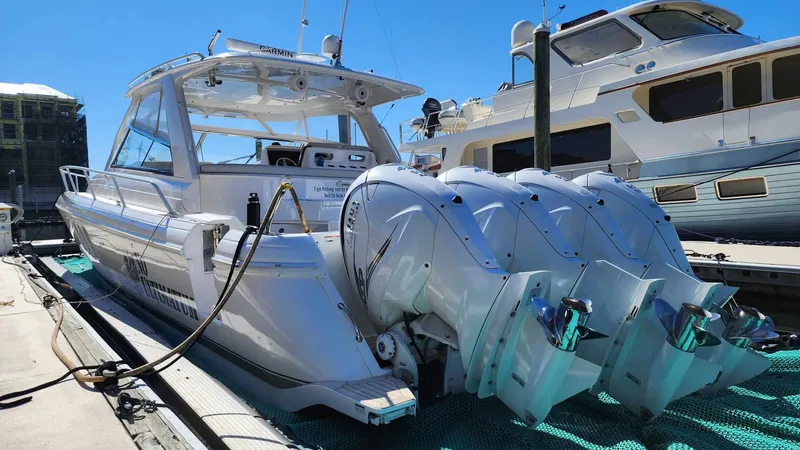 Slide: The Image of 2020 Intrepid 475 Sport Yacht docked with triple outboard engines. - 4