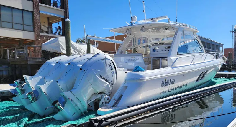 Slide: The Image of 2020 Intrepid 475 Sport Yacht docked with triple outboard engines. - 5