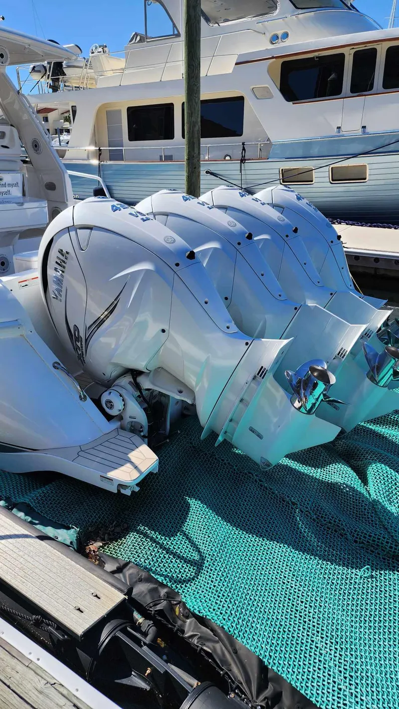 Slide: The Image of 2020 Intrepid 475 Sport Yacht with triple outboard engines docked. - 6
